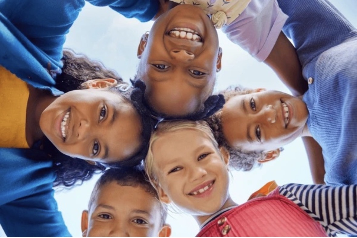 A joyful circle of children looking up together